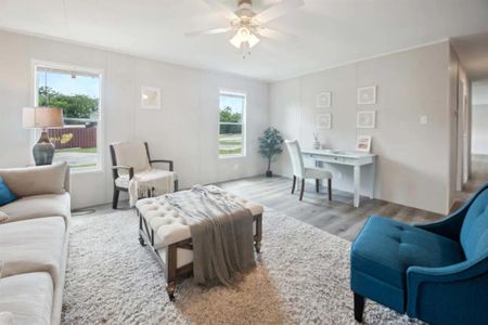 Living room with light hardwood / wood-style floors and ceiling fan