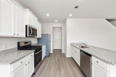 The kitchen comes with Whirlpool kitchen appliances and granite countertops.