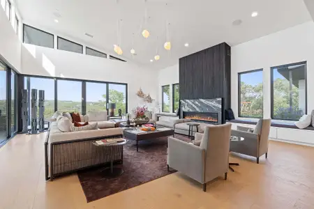 This truly captivating great room provides a refined contemporary environment to kick back, relax, and take in the amazing views while you gather with friends and family in front of the designer wall-mounted fireplace.