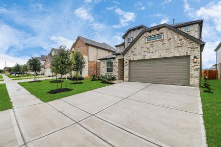 The residence features a practical 2-car garage complemented by a generous driveway, ensuring abundant space for parking needs.