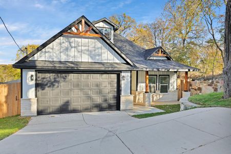 View of front of house featuring covered porch and a garage