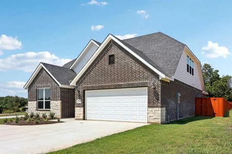 View of front of property with a garage and a front lawn