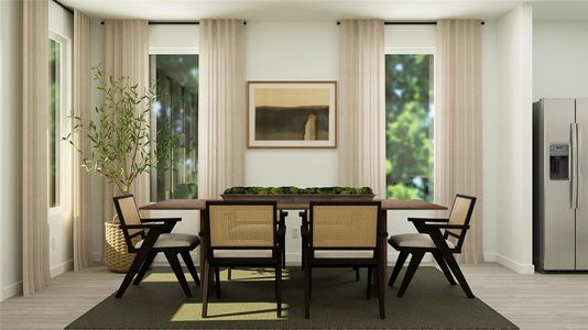 Dining room with light hardwood / wood-style floors and a wealth of natural light