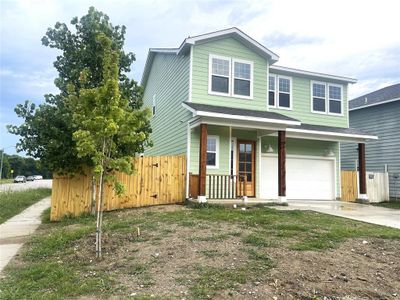 View of front of home with concrete driveway, an attached garage, a gate, and a porch View of front of home with concrete driveway, an attached garage, a gate, and a porch