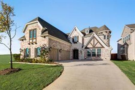 View of front of house with a front yard and a garage