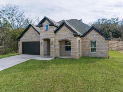 View of front of home featuring a garage and a front yard