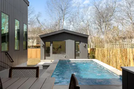 View of swimming pool featuring an outdoor structure, a storage structure, a fenced backyard, and a fenced in pool