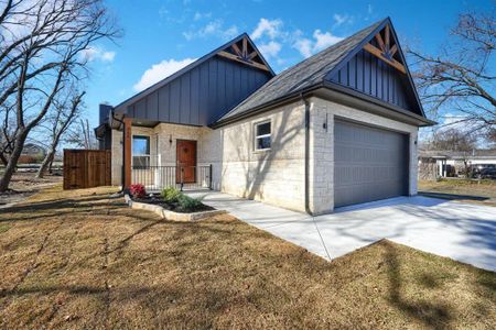 View of front of home featuring a garage and a front lawn