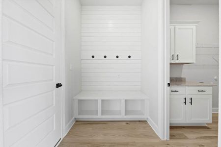 Mudroom and laundry room are conveniently adjacent as you enter from the garage.