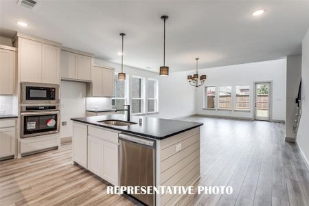 Featuring the perfect open concept design, entertaining is a breeze in our Toulouse floor plan.  REPRESENTATIVE PHOTO.