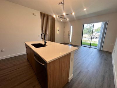 Upgraded cabinetry and lighting, quartz countertops, and wooden slats