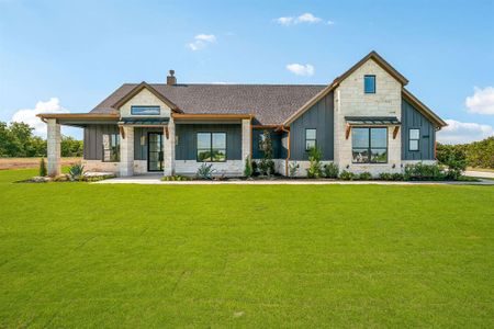 Modern farmhouse style home featuring a front yard