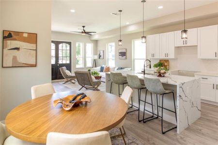 Dining area featuring sink, light wood-type flooring, and ceiling fan