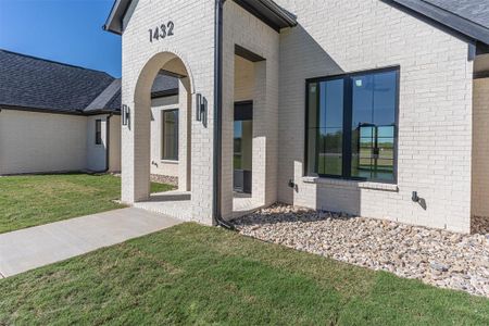 Entrance to property with a lawn