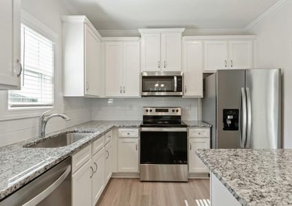 granite countertops and white cabinets in the kitchen.