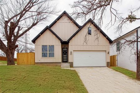 View of front of property with a garage and a front yard