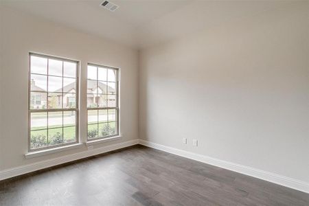 Spare room featuring dark hardwood / wood-style flooring