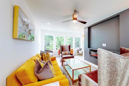 Living room featuring ceiling fan and hardwood / wood-style flooring