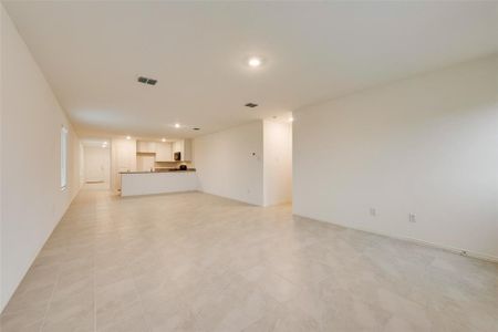 Unfurnished living room featuring light tile patterned floors