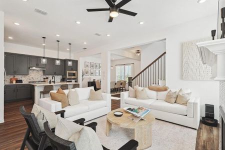 Living room featuring wood-type flooring and ceiling fan