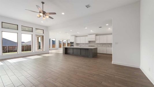 Unfurnished living room with hardwood / wood-style flooring and ceiling fan