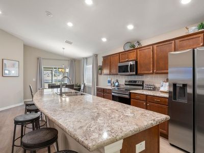 Enjoy a sunny kitchen, with Samsung ss appliances and a walk-in pantry,  open to the gathering room.