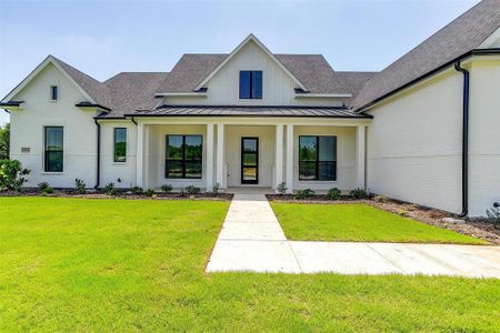 Modern farmhouse style home featuring a front yard