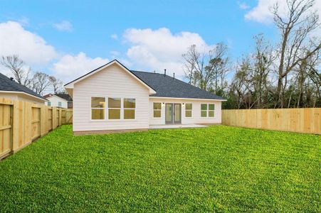 This photo showcases a modern single-story home with a spacious, fenced backyard. The exterior features a light facade and large windows, providing plenty of natural light. Ideal for families or those who love outdoor space. Lawn is a rendering in this photo