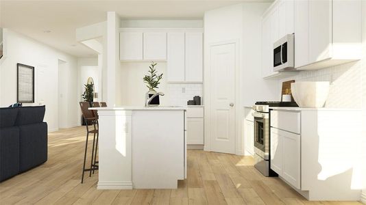 Kitchen with light hardwood / wood-style flooring, appliances with stainless steel finishes, and white cabinets