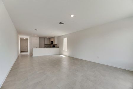 Unfurnished living room with light tile patterned flooring