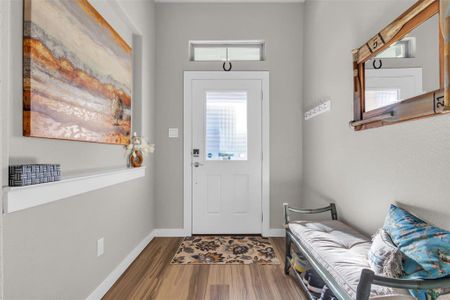 Foyer entrance with hardwood / wood-style floors