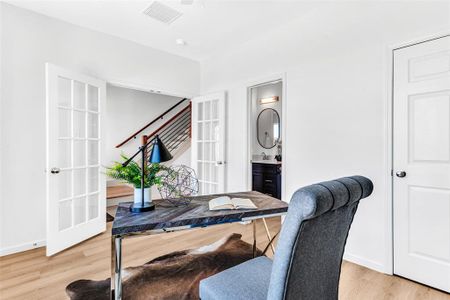 Office area with sink, french doors, and light wood-type flooring