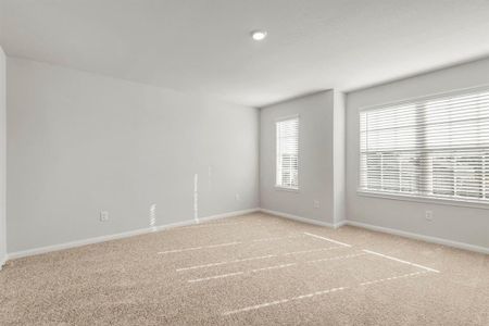 The expansive, primary bedroom is the perfect place to relax after a long day.