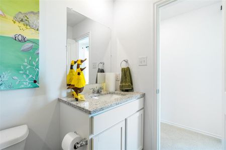 Bathroom featuring vanity and toilet