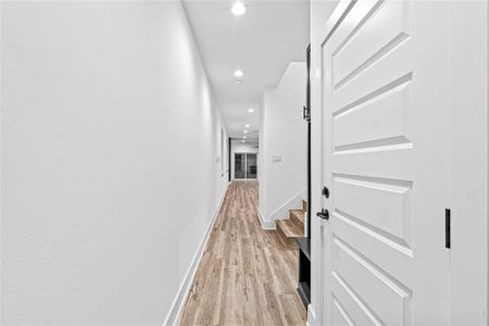 Hallway with light wood-type flooring