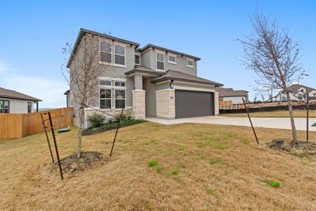 View of front of home featuring a front lawn and a garage