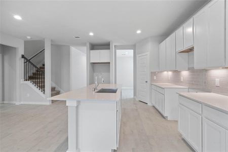 This kitchen is by far any chef’s dream! This spacious kitchen features high ceilings, white stained wood cabinets, quartz countertops, SS appliances, modern tile backsplash, recessed lighting, extended counter space for breakfast bar, and a walk-in pantry all overlooking your huge family room.