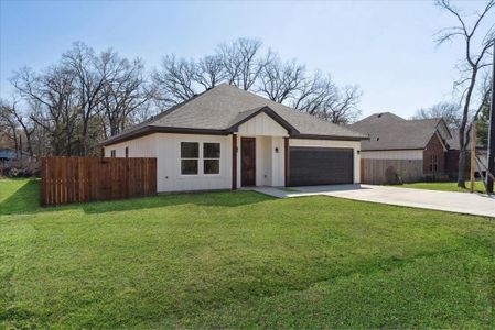 View of front of home with a garage and a front yard