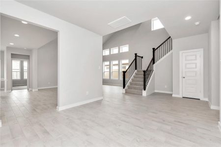 An inviting dining space seamlessly woven into the open concept, connecting the family room and kitchen. Revel in the stunning floors & soothing paint palette – a perfect setting for shared meals and cherished moments. Sample photo of completed home with similar floor plan. As-built interior colors and selections may vary