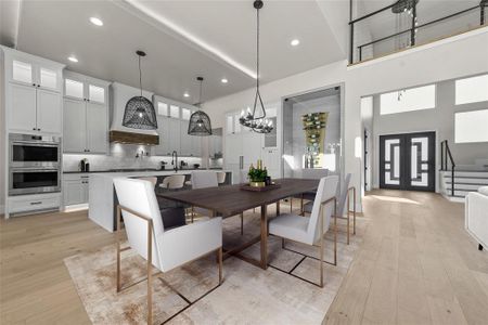 Your inner chef will revel in the high-end kitchen showcasing custom cabinets & range hood, 12’ ceilings, Wolf-Sub-Zero appliances & a generous island with seating for your whole family. This photo has been virtually staged.