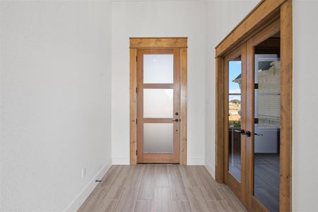 Entryway featuring french doors and light wood-type flooring