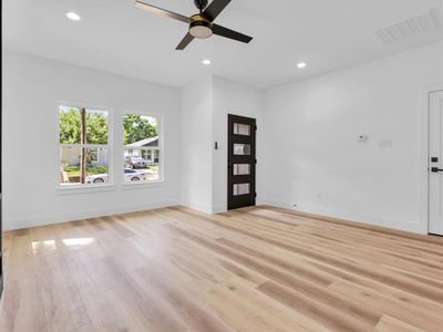 Unfurnished living room with light hardwood / wood-style floors and ceiling fan