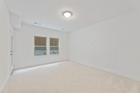 Unfurnished room featuring light colored carpet