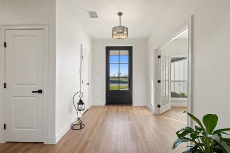 Entryway with a chandelier and light hardwood / wood-style flooring