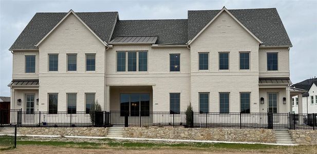 View of front of property - residence is the middle unit with the covered front porch.