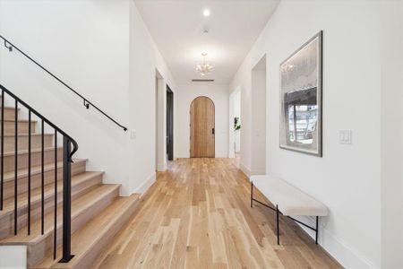 A solid wood door and iron handrail (with balusters elegantly drilled into the the steps) adorn the entrance and foyer.