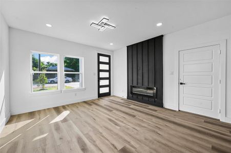 Unfurnished living room featuring light wood-type flooring