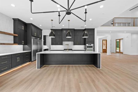 Sleek & elegant kitchen with ample cabinets, under mount and toe kick lighting.