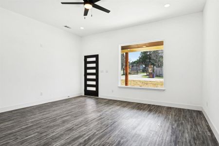 Unfurnished room with visible vents, baseboards, and dark wood-type flooring