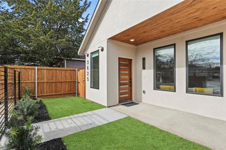 Doorway to property featuring a lawn